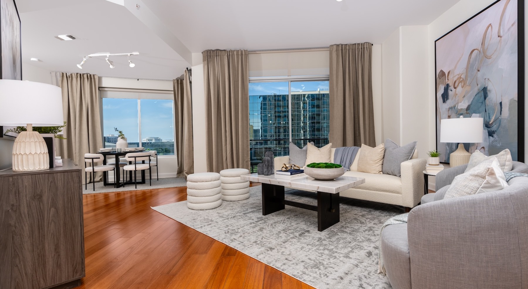 living room with seating table and large windows