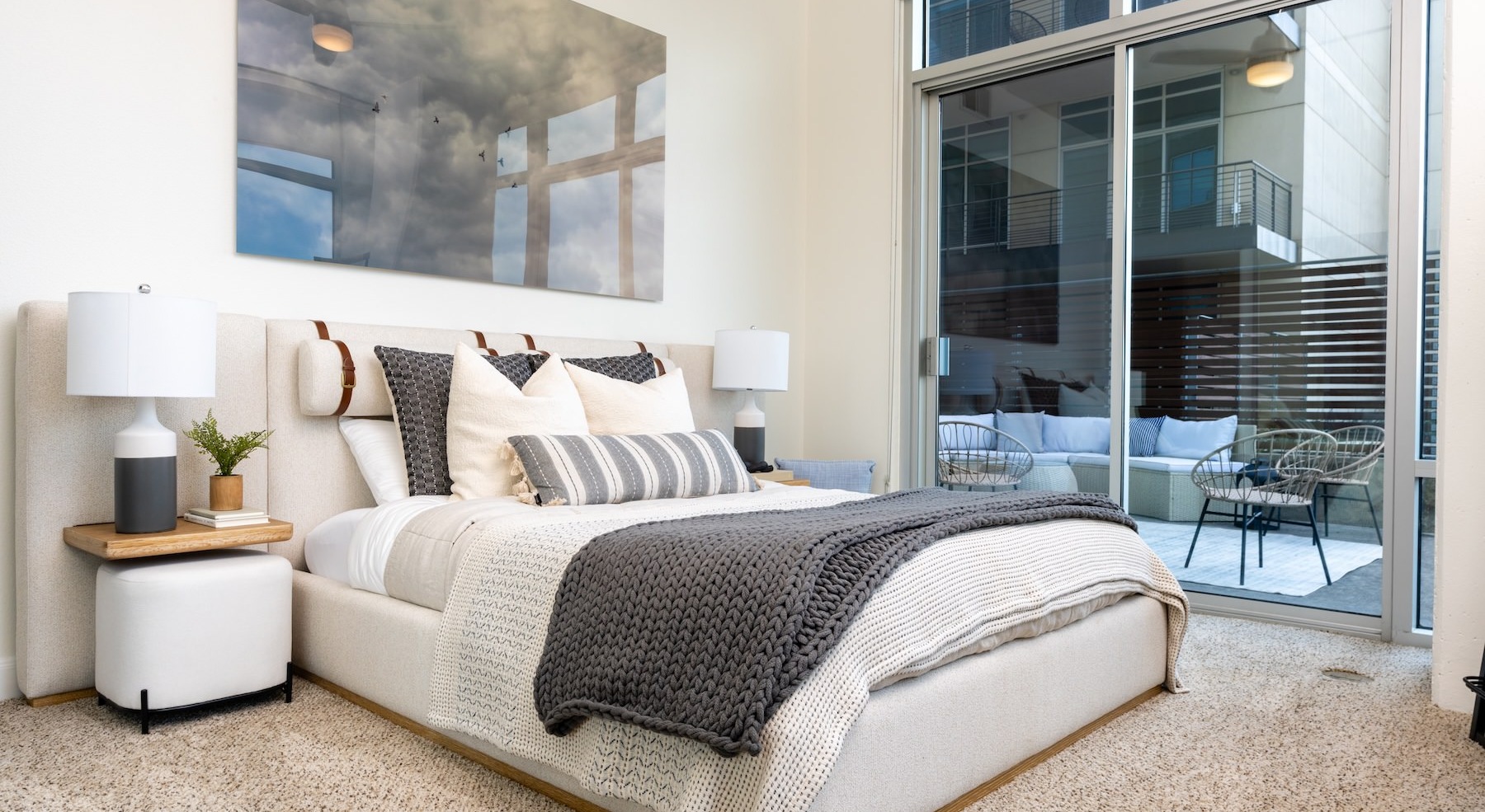 bedroom with bed lamps and large windows