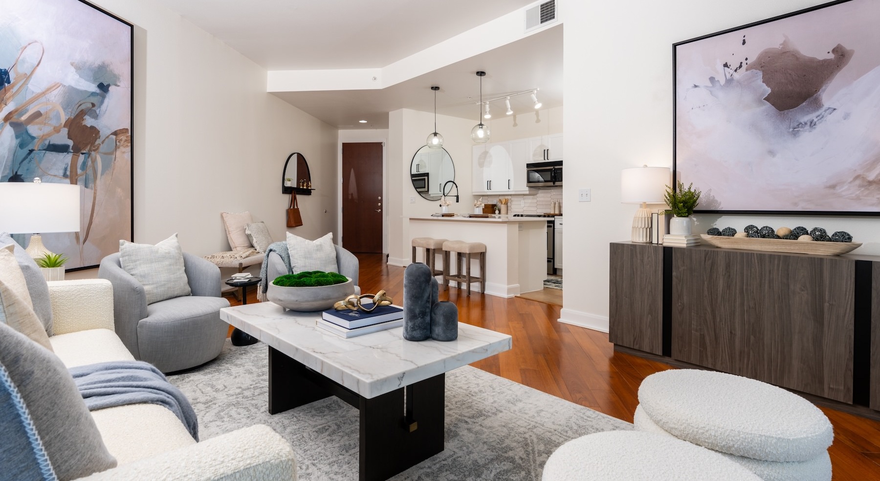 living room with furniture art and a view of the kitchen